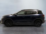 a blue suv parked in a room with a white wall