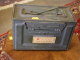 an old radio sitting on top of a wooden table
