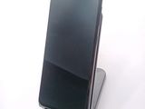 a cell phone that is sitting on top of a stand