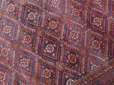 a close up of a red and blue rug with a pattern on it