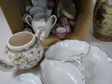 a box full of china dishes and cups on a table