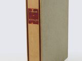 a book with a brown cover sitting on top of a white table