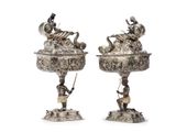 pair of silverplated candlesticks with figures on stands