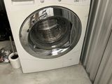 a washing machine that is sitting in the corner of a room