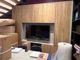 a room with a desk and a television in it