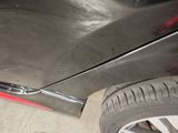 a close up of a car ' s front bumper with a red stripe