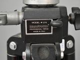 a close up of a tripod with a camera on it
