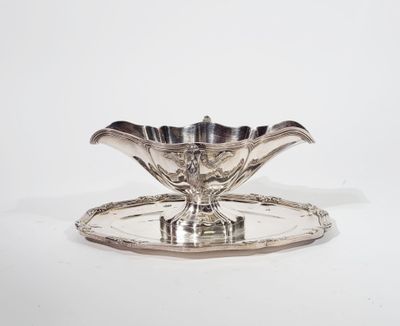 an image of a silver plate with a flower design on it