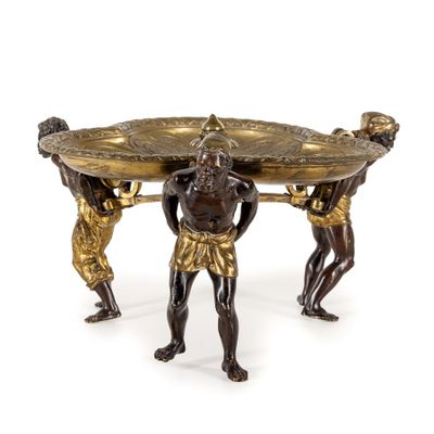 an image of a bronze table with three men holding a tray on top of it