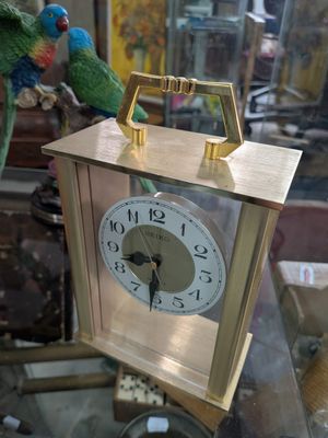 a clock that is sitting on top of a glass table
