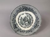 a black and white plate with a picture of a woman on it