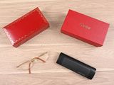 a red box and a pair of glasses on a wooden floor