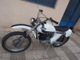 a white motorcycle parked on the side of the street