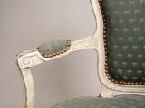an old chair with a green upholstered upholstered seat and gold studding