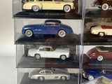 a lot of different models of cars in a display case
