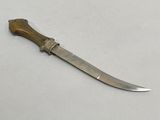 an old knife with a wooden handle on a white surface