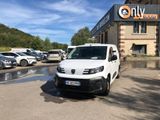 a white van parked in front of a building in a parking lot