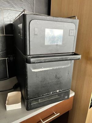 a black refrigerator sitting on top of a kitchen counter