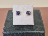 a close up of a pair of earrings sitting on top of a box