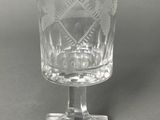 a glass with a design on it on a table