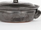 a close up of a metal pot with a lid