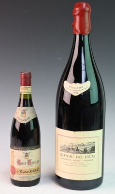 two bottles of wine sit next to each other on a table