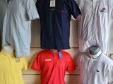 a lot of men ' s polo shirts on display in a store