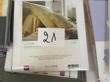 many sheets of paper on a table with a price tag