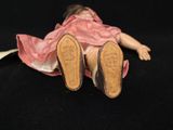 a doll that is laying down on the floor