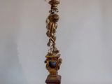 an image of a gold colored lamp with a statue on top of it