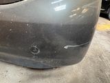 a close up of a car ' s front bumper with a hole in it