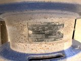 a close up of a blue and white vase on a table