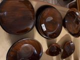 many wooden bowls and pans on the wall