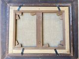 an old picture frame with a picture hanging on the wall