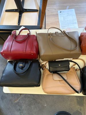 a lot of purses that are on a table