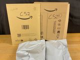 two boxes of amazon ' s new products are sitting on a table