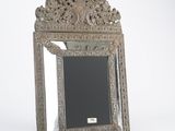 an antique silver mirror with ornate design on a white background