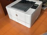 a white printer sitting on top of a wooden table