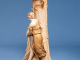 a statue of a woman leaning against a column