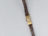 an old leather watch strap with a gold buckle