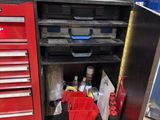 a red tool cabinet with tools in it in a garage