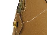 the inside of a brown purse with a zipper on it