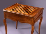 an old wooden table with a chess board on top of it