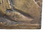 a bronze statue of a woman with a bird on her shoulder