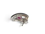 a close up of a silver ring with a red stone in it