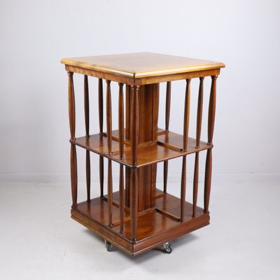 a wooden table with four shelves on wheels on a white background