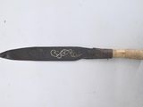 a knife that is laying on a white surface