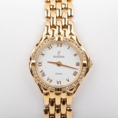 an image of a close up of a wrist watch on a white surface