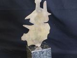 an image of a sculpture of a bird sitting on top of a stone block
