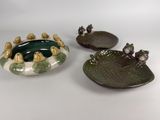 two green and white dishes with birds on them sitting next to each other
